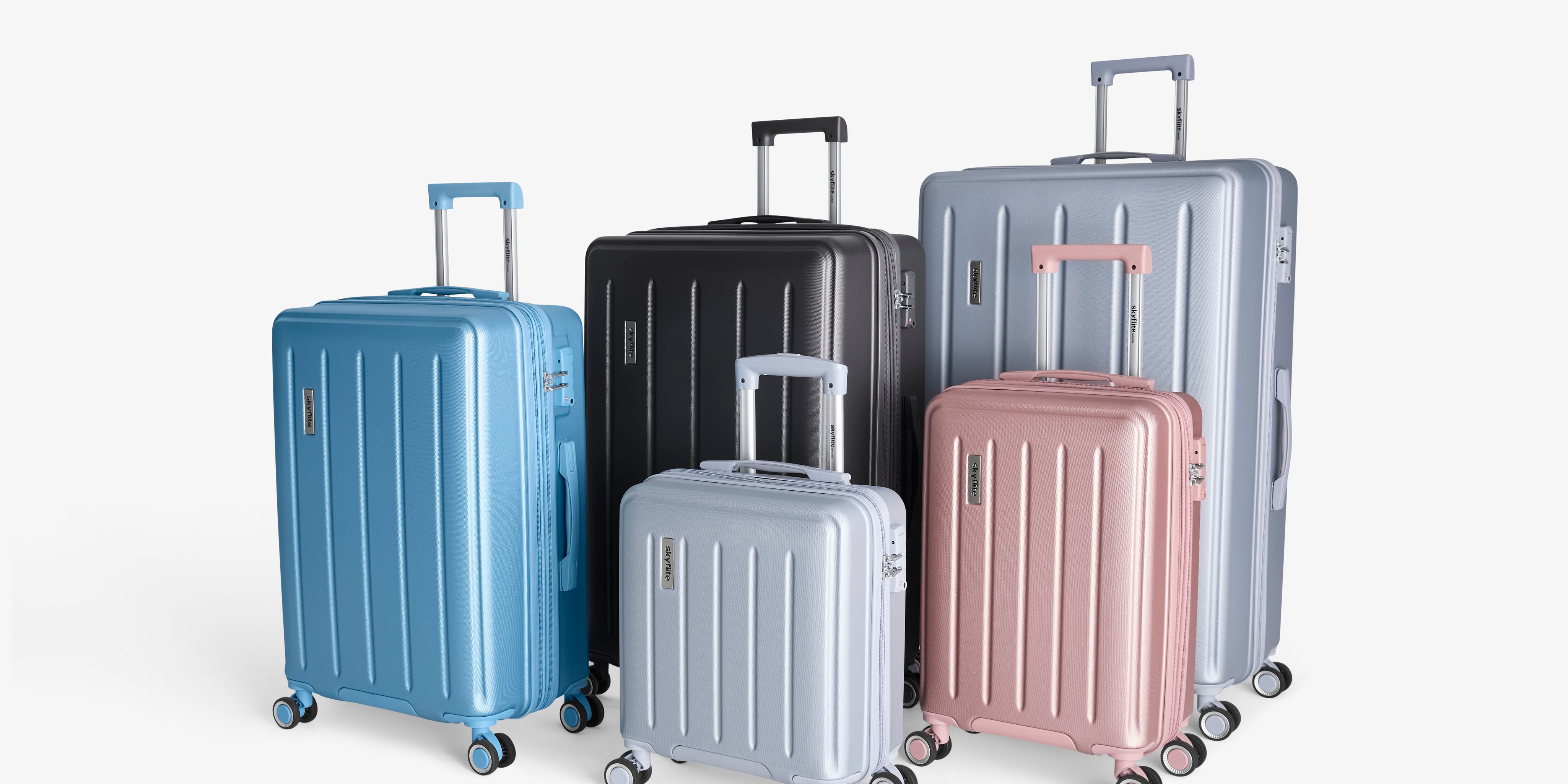 A stylish set of three charcoal grey Skyflite Dolomite hard-shell spinner suitcases, arranged by size to showcase the luggage collection.