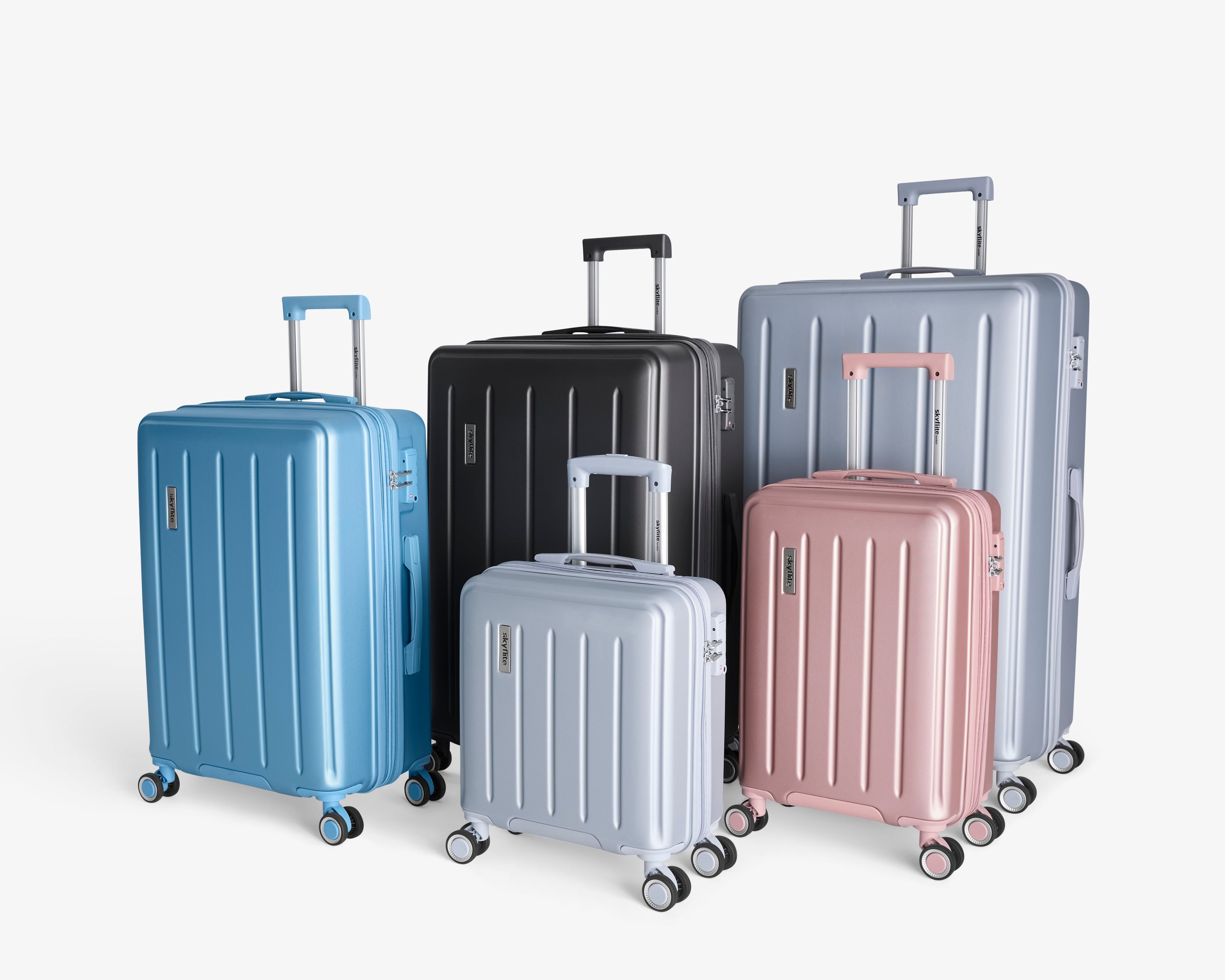 A stylish set of three charcoal grey Skyflite Dolomite hard-shell spinner suitcases, arranged by size to showcase the luggage collection.