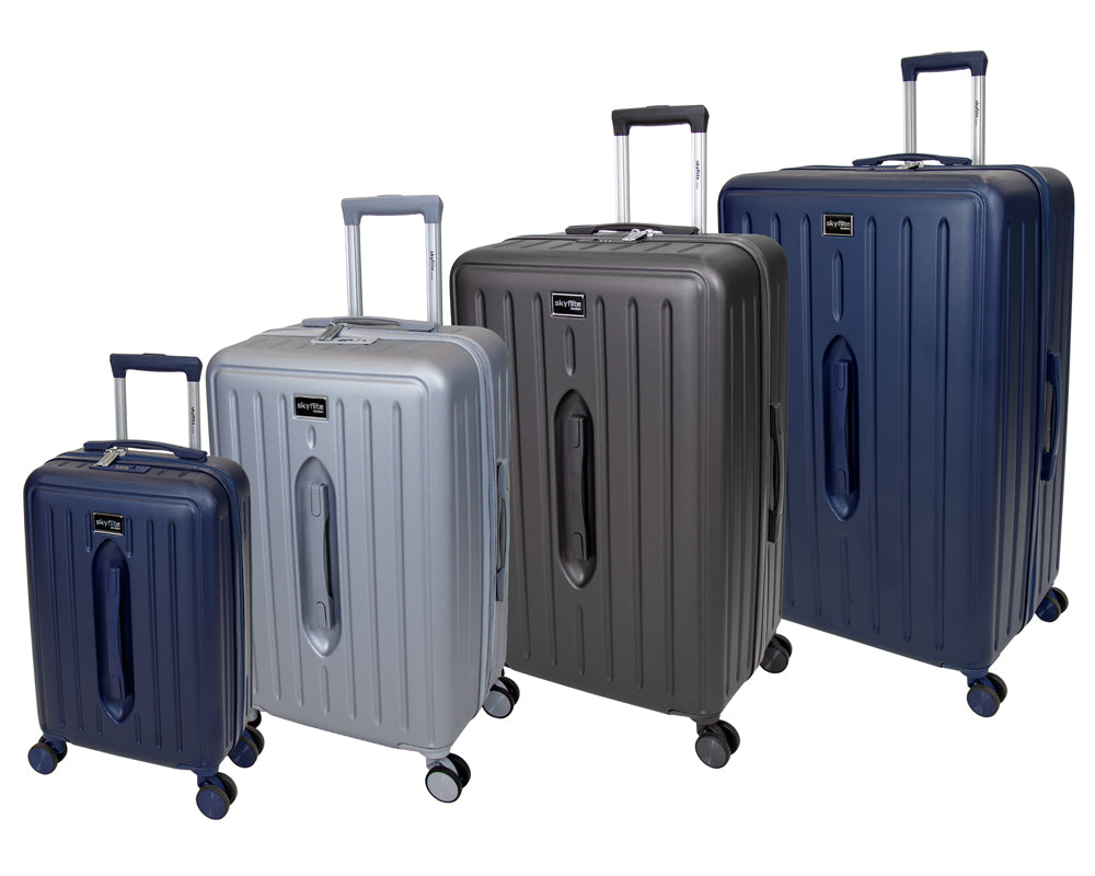The complete Skyflite Modern Trunk luggage collection, featuring four off-white contemporary hard-shell cases with tan strap details, lined up from largest to smallest.