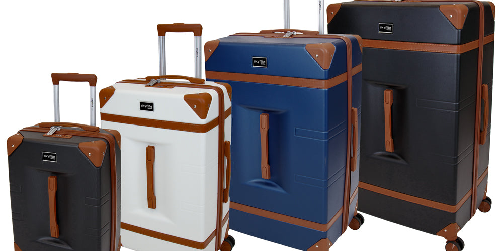 A stacked set of three cream and tan Skyflite Retro Trunk suitcases in a classic, vintage style.