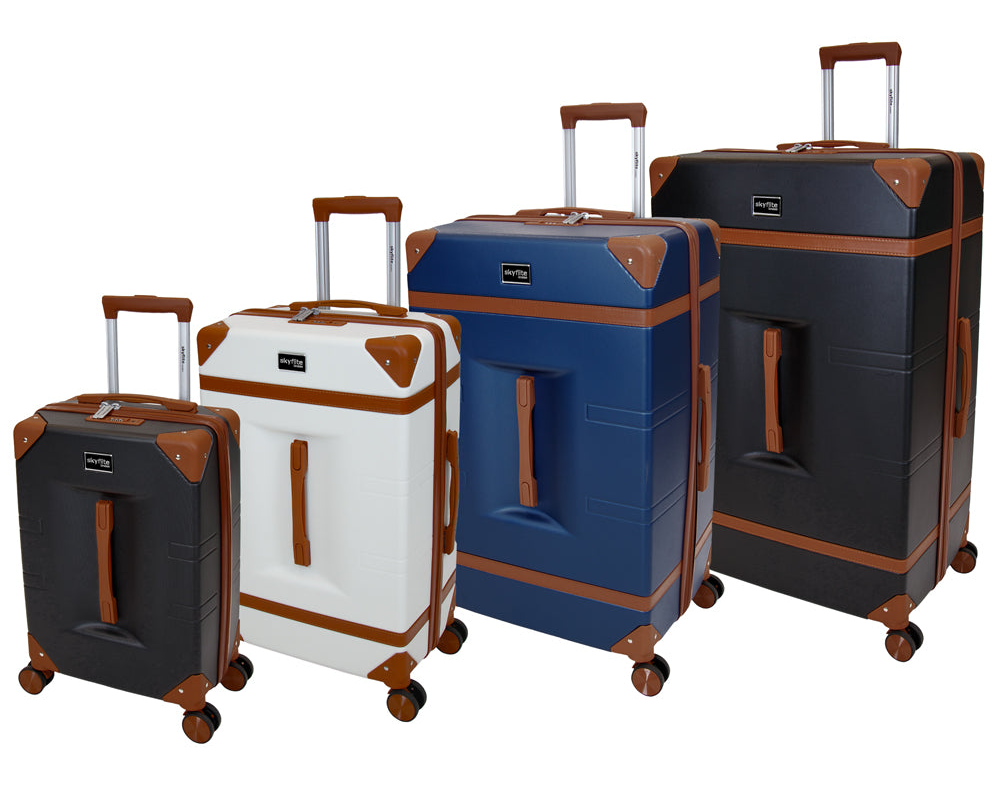 A stacked set of three cream and tan Skyflite Retro Trunk suitcases in a classic, vintage style.