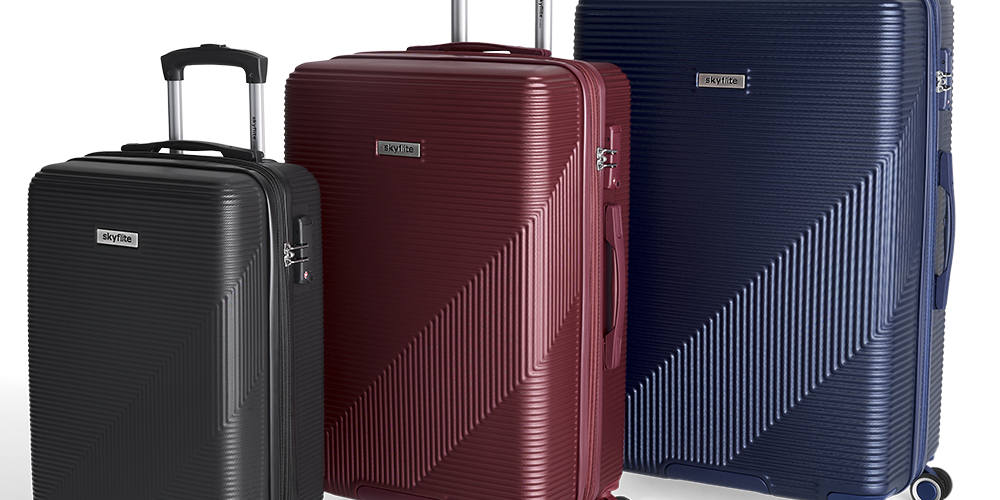 The Skyflite Zest luggage collection in three sizes—large, medium, and cabin—all in a vibrant teal with colour-coded spinner wheels and fittings.