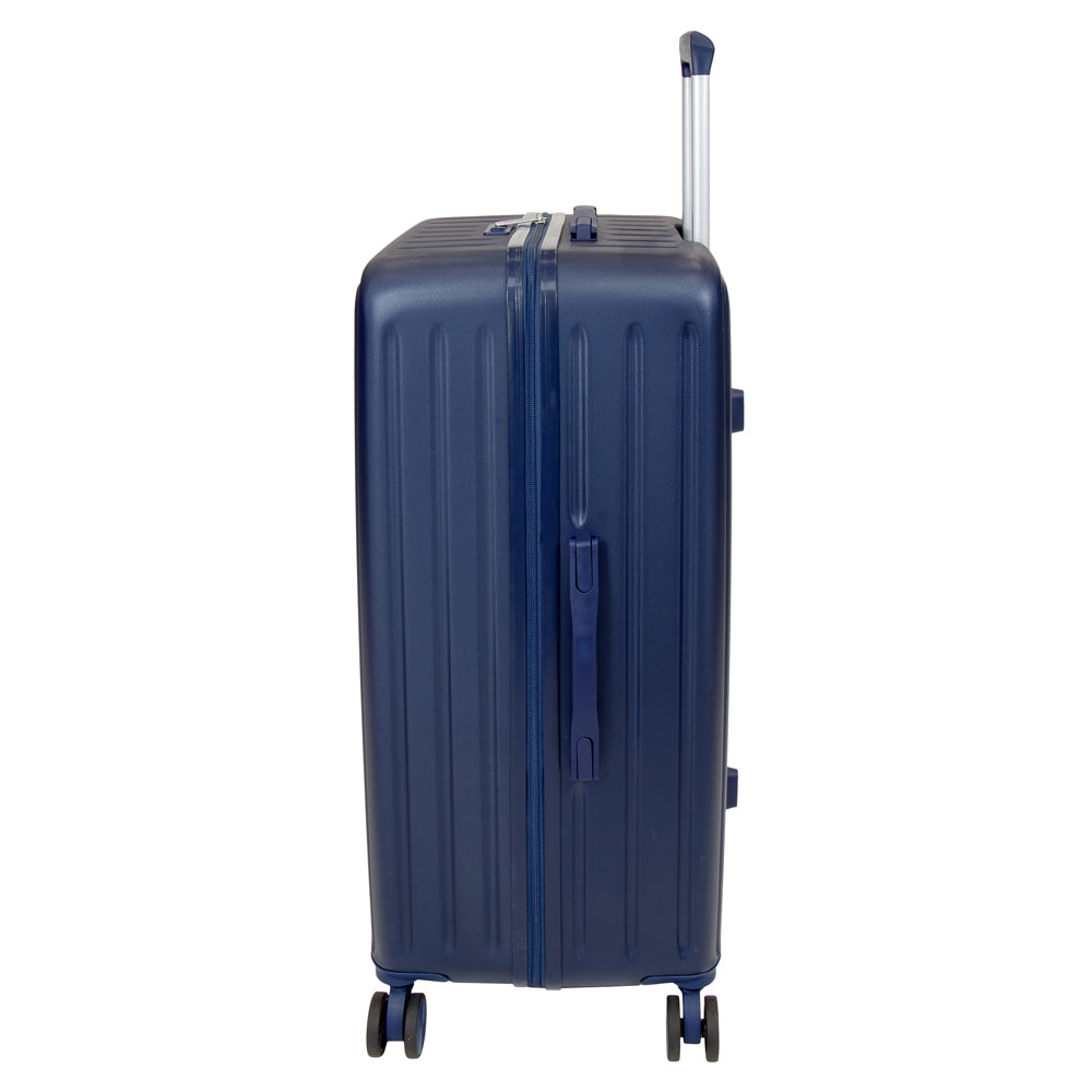 Side profile of the navy blue Skyflite Modern XL Trunk, an 86cm hardshell suitcase featuring eight smooth-rolling spinner wheels and a side carry handle.