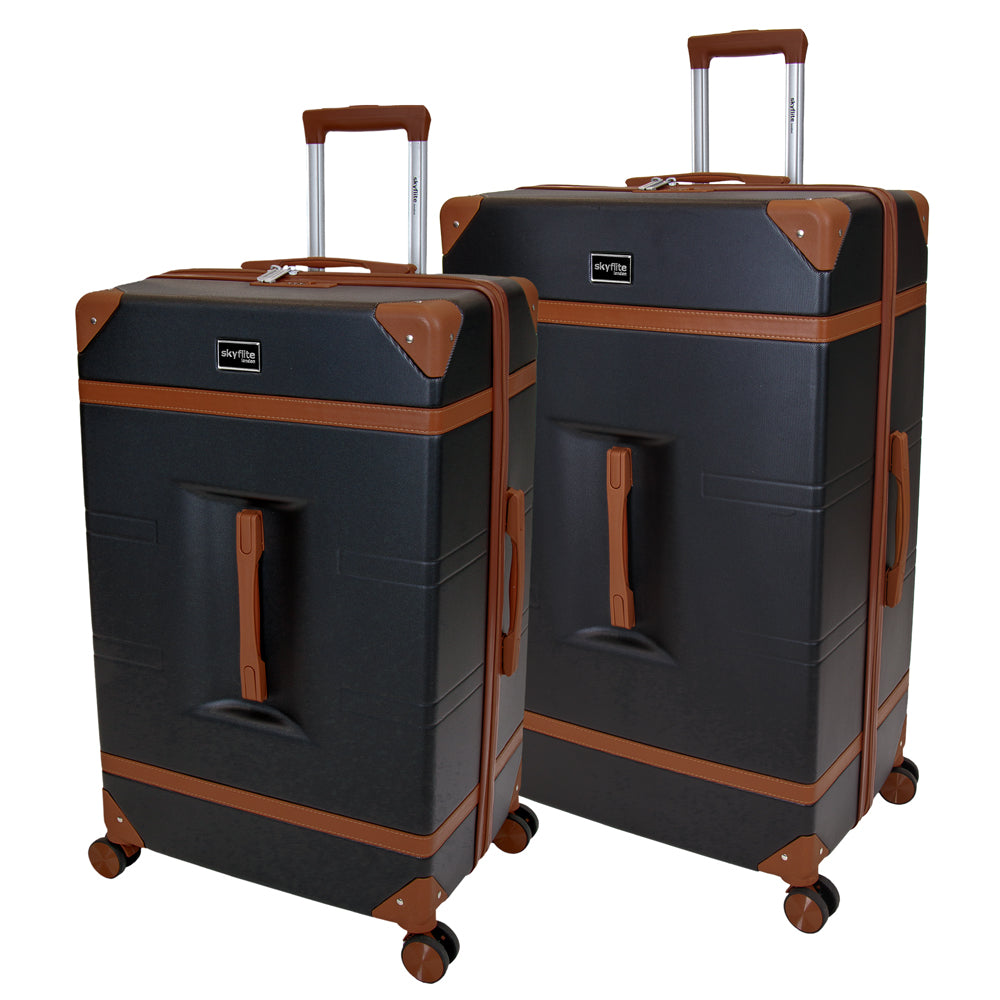 Skyflite Retro Trunk 2-piece hardshell luggage set in black, with the large and carry-on suitcases standing together on their 360° spinner wheels.