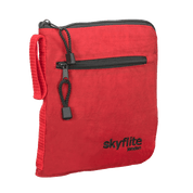 Red Skyflite folding onboard travel bag shown neatly folded into its compact, zippered pouch for easy storage.